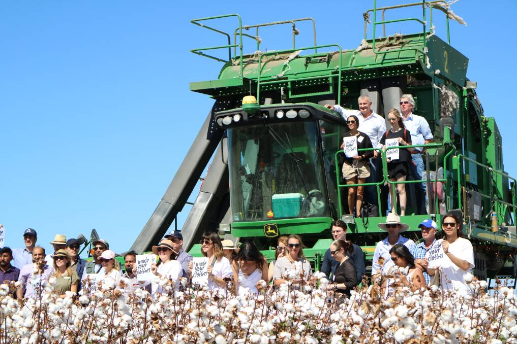 Attendees exploring the cotton field and a cotton picker at Auscott, Narrabri. 