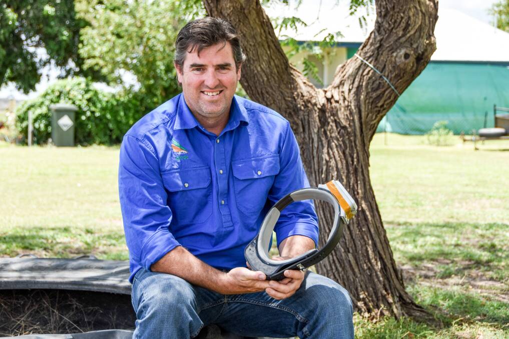 Queensland Murray Darling Committee Feral Animal Officer Darren Marshall with one of the GPS collars they are using on feral pigs.  