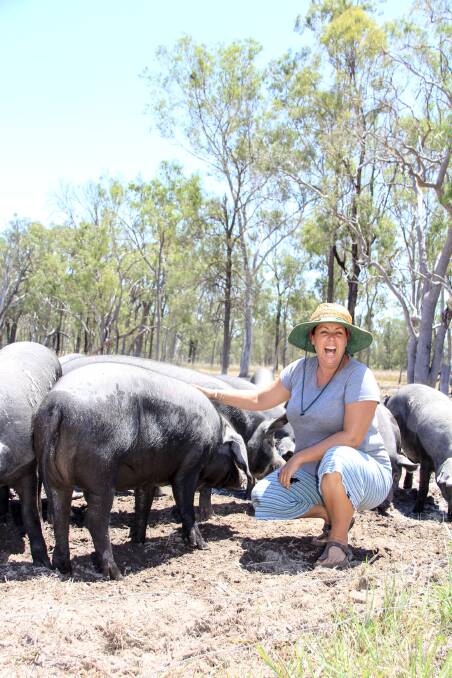 Julia Powell with some of the pigs at Backfatters Heritage Breed Free Range Pig Farm near Biggenden. 