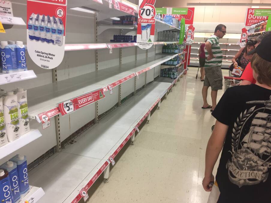Mayhem in the supermarket! Bread and milk supplies are being snapped up by worried Queenslanders. 