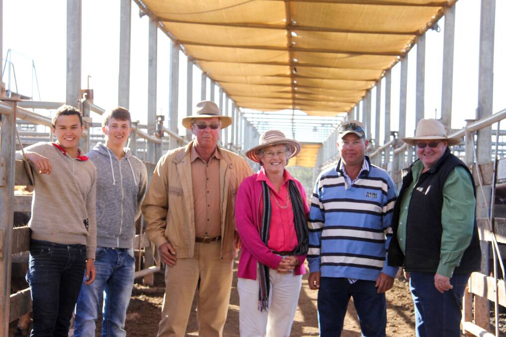 The McLean family and Steve Hancock show their newest visitors helping on the property around the saleyards. 