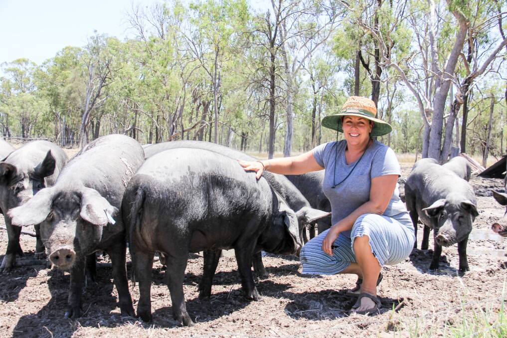 Julia Powell with some of the pigs at Backfatters Heritage Breed Free Range Pig Farm near Biggenden.