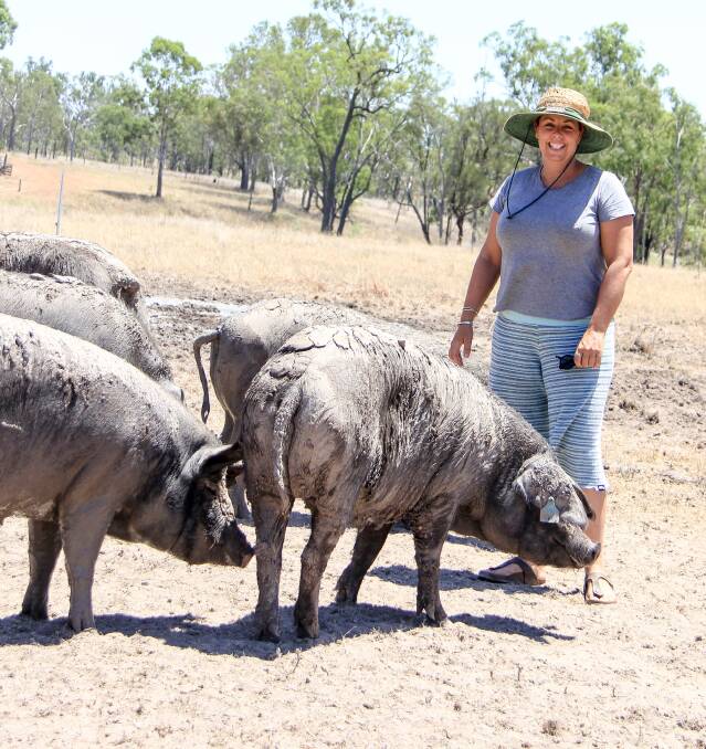 Julia pictured with some of the pigs on their Biggenden property. 