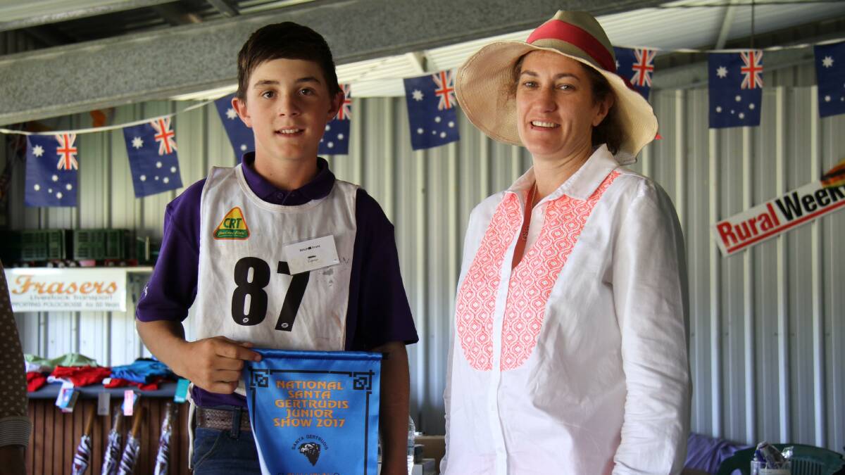 Mitch Franz, Jandowae, was congratulated by Wendy Ferguson, Glenn Oaks Stud, Nobby, for winning the  Champion herds-person and took home a heifer donated by the Ferguson family.