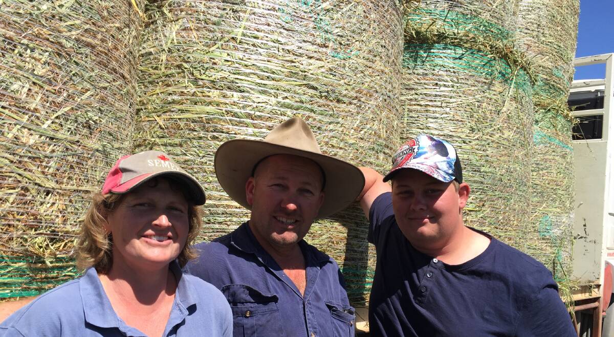 HAY HAY: Dairy farmers Tammy and Ricky Gill and their son Jackson in the process of wrapping one-tonne round bales at Gilbrae, Roxburn.