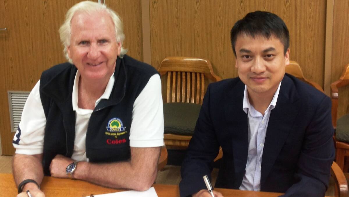 DEAL DONE: Australian Country Choice chairman Trevor Lee and Genius Link chairman Xue Jing Yuan signing the memorandum of understanding.
