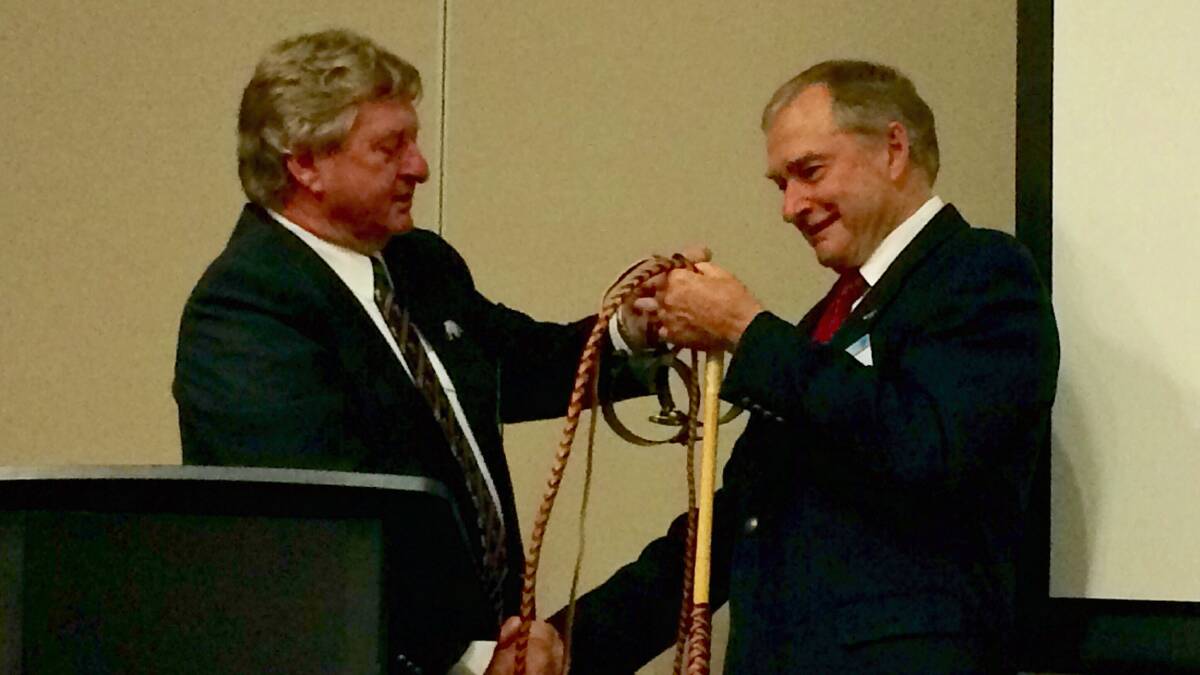Vaughan Johnson presenting Howard Hobbs with a whip at Howard's farewell in 2015 in Roma. Picture supplied. 