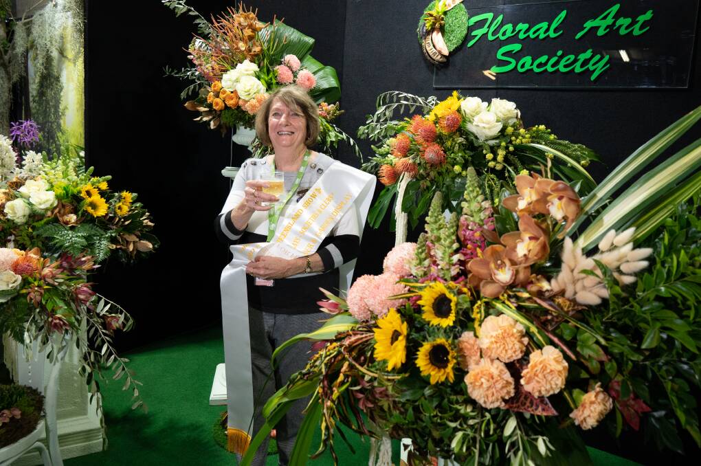 Floral Art Society of Queensland president Heather Prior toasts their display's third prize.