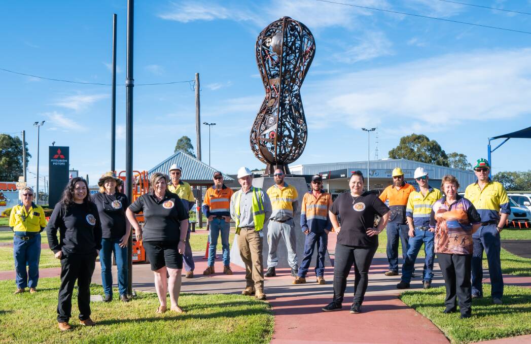 NUTTY NEW ADDITION: Organisers, council and businesses check out Kingaroy's new Big Peanut sculpture on Thursday. From left: Tracey Stark, South Burnett Regional Council, Abigail Andersson, Tina Torrens and Janene Steinhardt, Kingaroy Needs A Big Peanut committee, John Howard, SBRC, Neville Page, AM Cranes, Garry Perfect, SBRC, Jamie Sellars, Ergon Energy, Mick Cuolahan, AM Cranes, Kristy Board, KNABP, Paul Reeves, Paul Reeves Carpentry, Mitch Gray, AMG Electrical, Rowena Dionysius, KNABP, and Lucas Bell, SBRC. Photos: Nancy Jayde Photography.