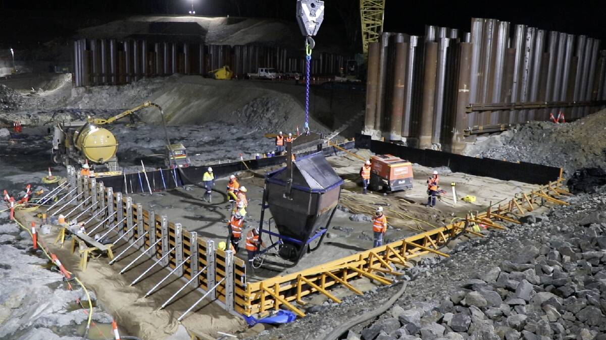 Workers pour concrete at the new Rookwood Weir project.