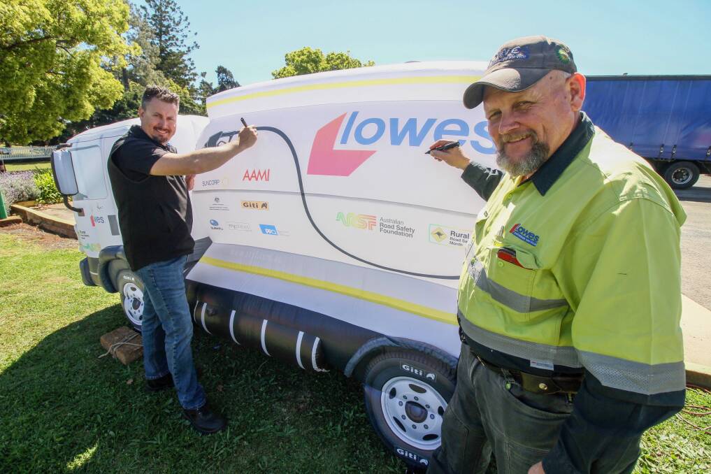 STAYING SAFE: Lowes Petroleuem Toowoomba depot manager Stefan Dawidowicz and Lowes truck driver Nat Barton with the inflatable truck that will make its way across regional Queensland. Photo: Lowes.