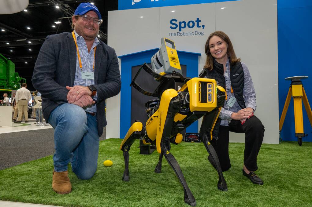 Trimble Asia Pacific sales director Adam Wall and Tori Oberholtzer, Denver, US, with Spot the dog. Pictures: Brandon Long