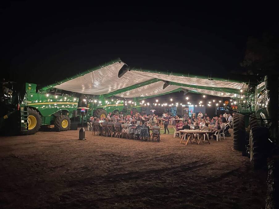 MECHANICAL MATRIMONY: Kingsley and Chloe Vandersee used combine harvesters to build their reception venue. Photo: Supplied.