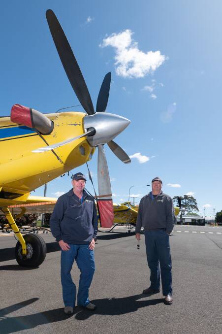 Precision Aerial pilots Michael Smith (left) and Roy Dawson in front of one of the company's Air Tractor AT-802F aircraft.