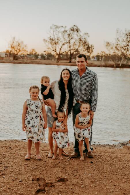 NEW ADVENTURE: Maryellen Boyd Blacket and husband Scott Blacket with their children Maryjane, 7, Boyd, 1, Violet, 2, and Dakota, 5, on the banks of the Burke River, where Boulia Caravan Park is situated. Photo: AliB Photography