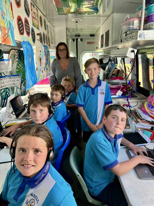 New South Wales education minister Sarah Mitchell checking out one of the mobile classrooms while the children work on their laptops. Photo: Supplied