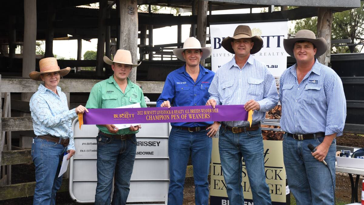 Stephanie and Lance Whitaker receive their award from overall champion pen at the Biggenden weaner sale.