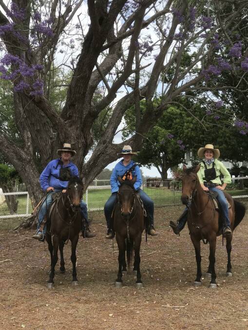 Scott, Jack and Bridget Madigan on their horses under the jacaranda tree during the drought. Photo: Supplied