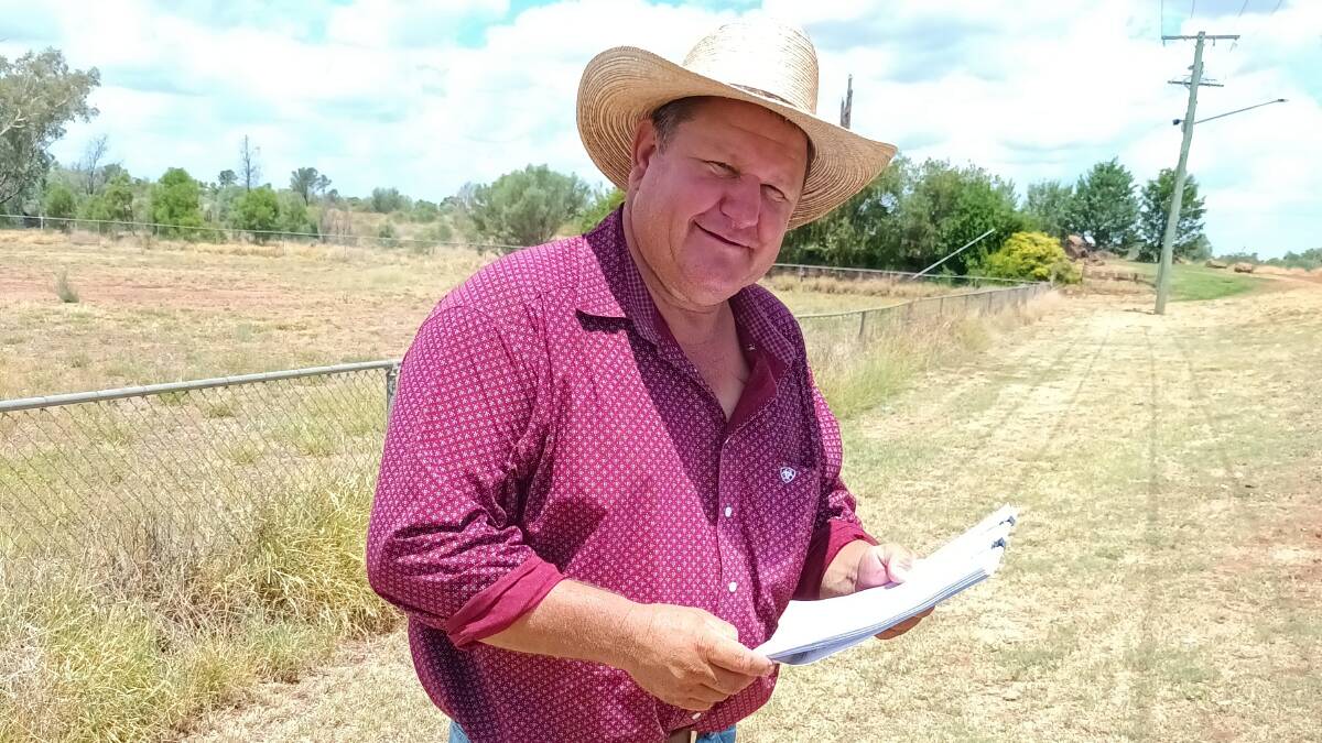 Dustin Tuite of Cunnamulla reviewing the wild dog fence specifications under the latest announcement. Picture: Supplied Paroo council
