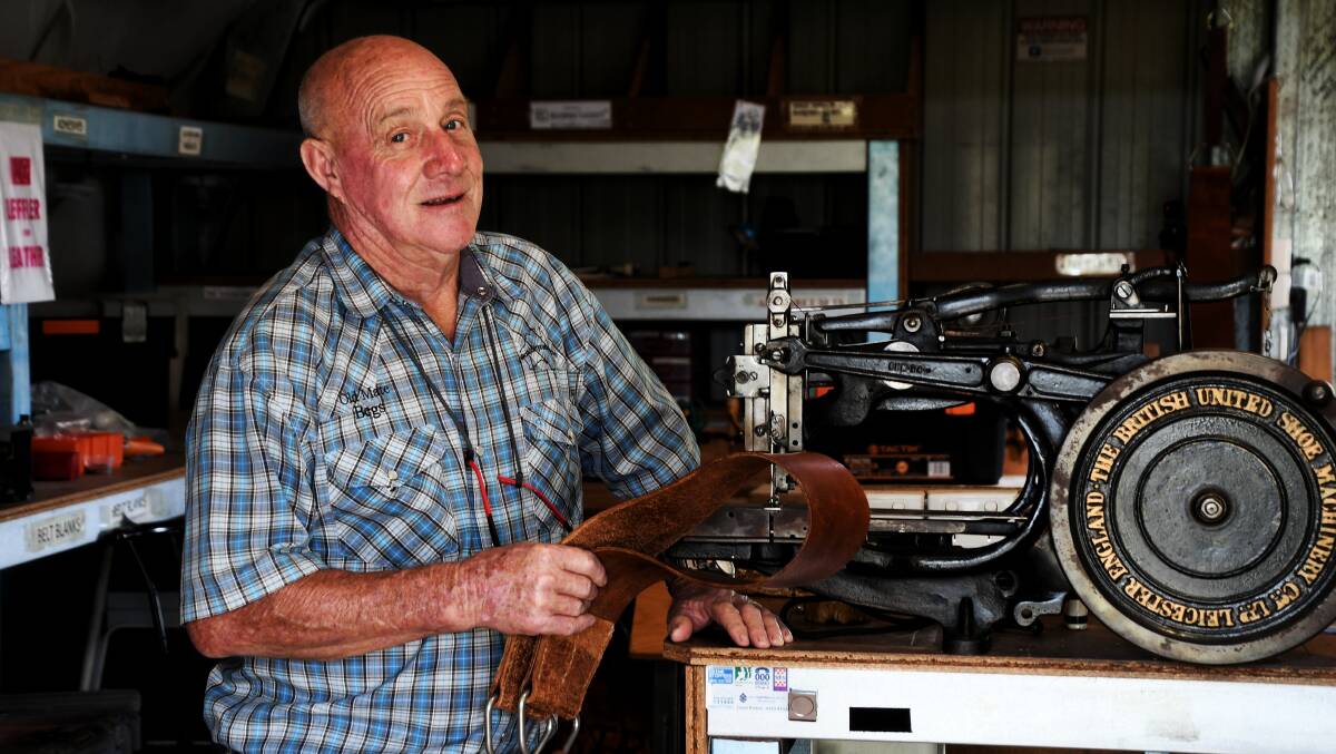 Gary "Begs" Begley with a more than 100-year-old Pearson sewing machine, used in the saddle making. Picture: Brad Marsellos