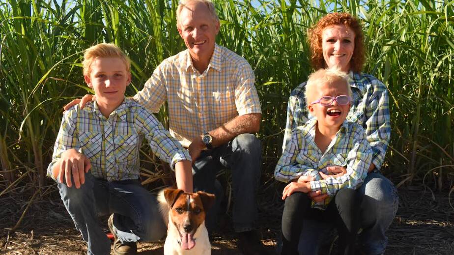 Irrigators Jeff and Judy Plath with their children Mark and Sarah, and dog Eddie. The family relies on water supplied from Paradise Dam to grow 14,000 tonne of sugarcane per year at their property in Farnsfield, near Childers. Picture supplied 