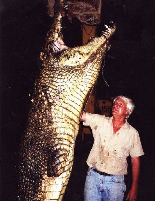 John Lever with a 4.9 metre crocodile which died in a fight with a larger male at his Koorana Crocodile farm. The crocodile was caught near Airlie Beach in the mid 1980s. Pic supplied