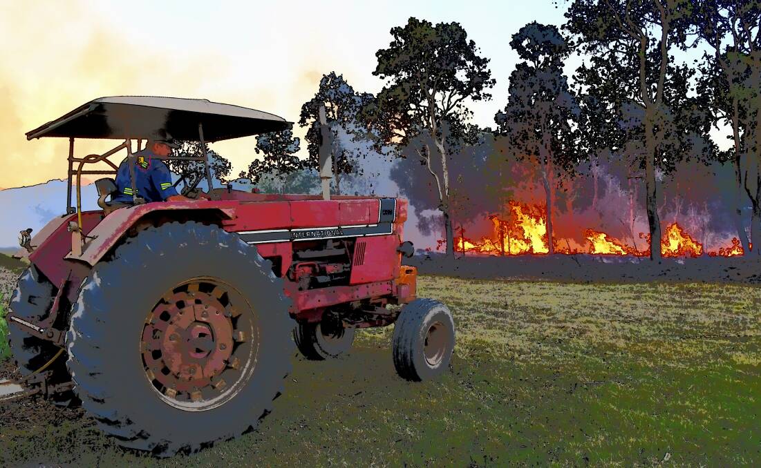 A tractor loaded with water on standby for a controlled burn. Picture: Judith Maizey