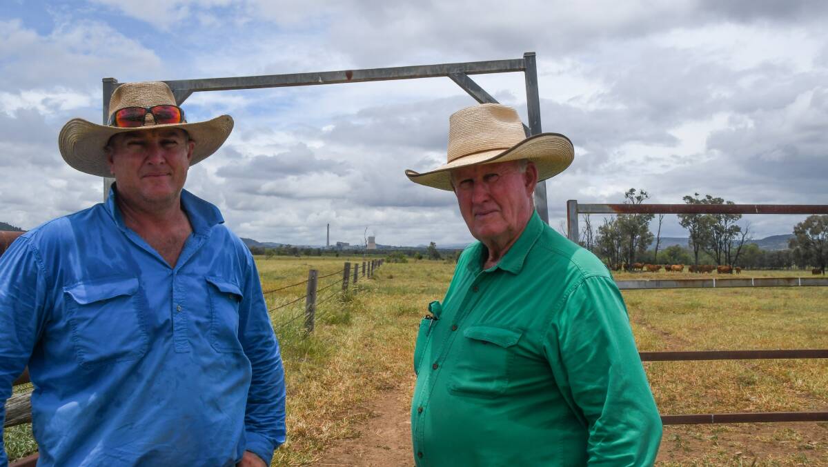 Larry Acton and his son, Richard, with the Callide Power Station in the distance. Picture: Judith Maizey