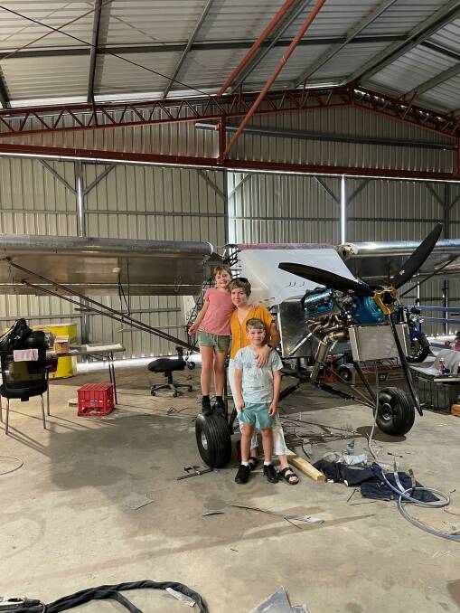 Cameron 'Sparrow' Obst's wife Taneal, son Connor, 10 and daughter Aleera, 9, with the aircraft he is building to help raise money for the RFDS with a new record for take-offs and landings in one day. Picture: Supplied