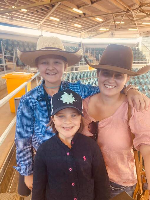Kayla McIntyre taking Chelsea and Madalyn Collins out to the saleyards at Charters Towers. Picture: Supplied 