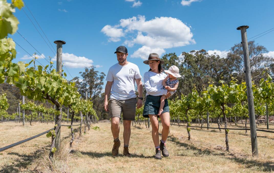 New owners of Ravenscroft Vineyard in Stanthorpe, Nick and Caitlin Roberts with their daughter. Picture: QRIDA