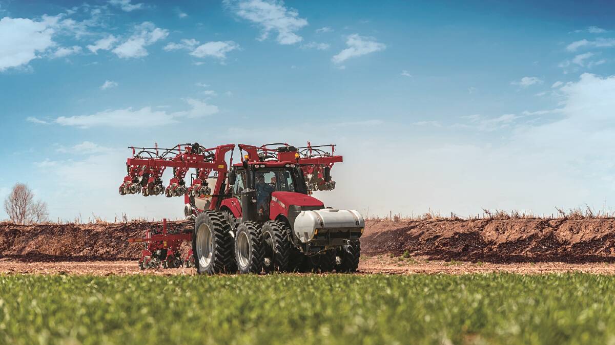 ON THE MOVE: A Magnum 380 with an Early Riser 2130 stack-fold planter.