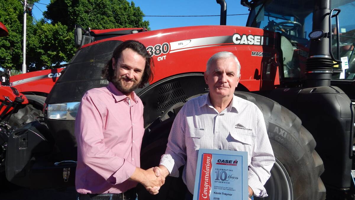 Case IH, Australian general manager, Pete McCann presenting Kevin Traynor with plaque celebrating his ten years of service.
