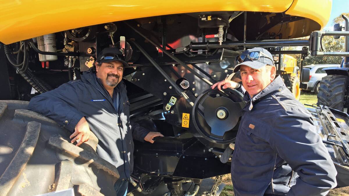WEED DESTRUCTION: Max Herbert, McIntosh Distribution, and McIntosh and Son WA southern branches manager, Devon Gilmour showcasing the iHSD fitted to a New Holland CR10.90 combine harvester at the recent Newdegate Machinery Field Days in WA.