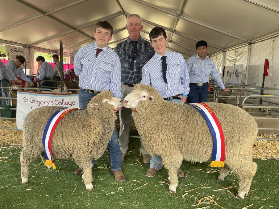 Champion ewe led by Ben Harrison, St Gregory's College, Camperdown, with judge Ric Houlihan and champion ram shown by Max Gorey, St Gregory's College, Campbelltown.