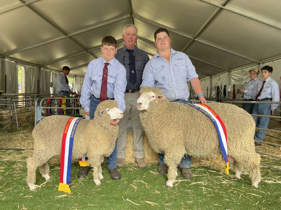 Ric Houlihan, judge of the Schools Classes, with students from St Gregory's College, Camperdown, Liam Coyle with the champion ewe and Will Hackett, with the champion ram.