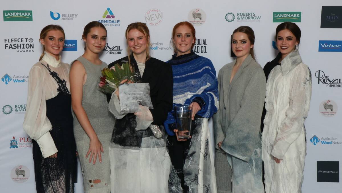 Fashion design winner: Madi Hislop with the winners bouquet surrounded by models wearing her designs which were awarded the New England Woolgrowers Supreme Award for 2019. Photo: supplied
