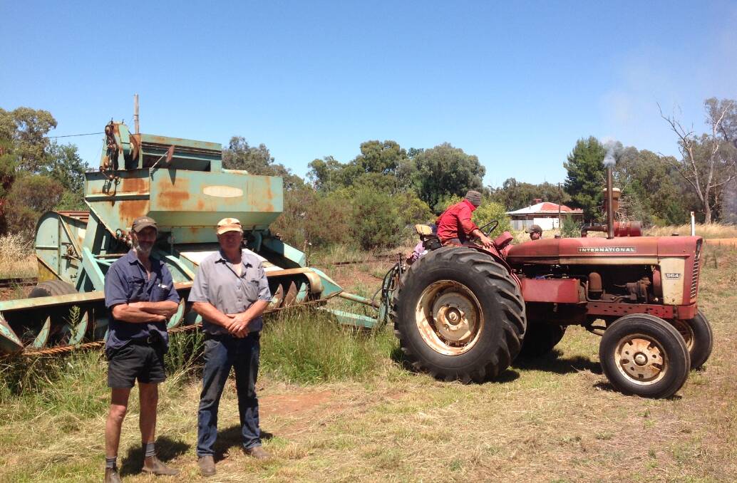 Vintage harvest: Wayne Hueske and John Staniforth with the Shearer 105 PTO header and the International 564 tractor. 