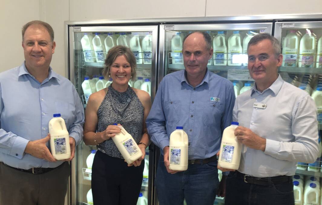 Australian Dairy Farmers chief executive officer, David Inall, with dairy farmers Erika Chesworth, Dubbo (NSW Farmers), and Graham Forbes, Gloucester (Dairy Connect), and Woolworths managing director, Brad Branducci, holding bottles of two litre private label milk about to rise in price to $2.20 each in Woolworths' stores.