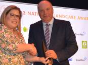 The winner of Landcare Australia's highest gong, Bruce Maynard, Narromine, NSW, collects the 2022 Bob Hawke Award from Department of Agriculture, Water and the Environment director, Karen Walsh, at the Sydney national conference.
