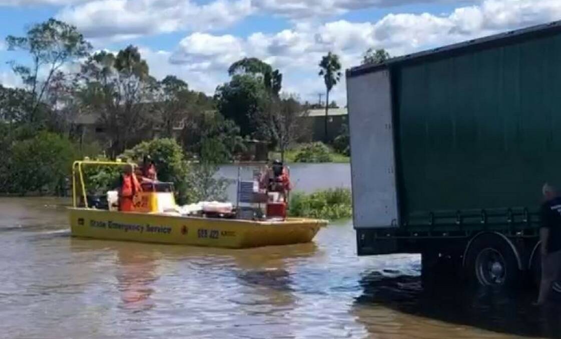 State Emergency Services flood boats delivering food supplies via the flooded Hawkesbury River 