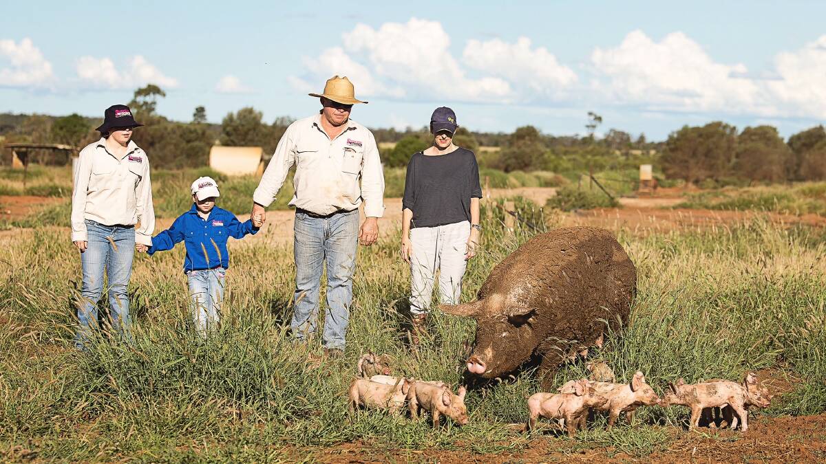 Pork producers Mark and Charisse Ladner, and daughters Tiggy and Bonnie, on their Southern Queensland farm.