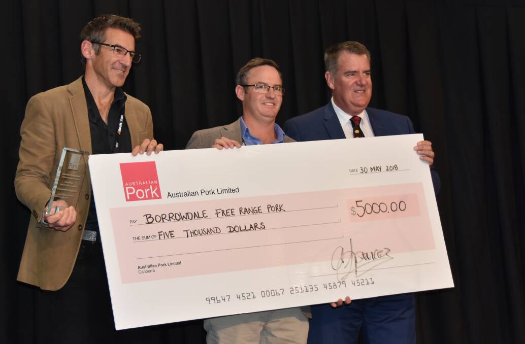 Borrowdale's marketing manager Paul da Silva and sales manager Jamie Ferguson accept first prize in the Steak Your Claim pork loin steak competition from Queensland Minister for Agriculture Mark Furner at the Pan Pacific Pork Expo on the Gold Coast yesterday. 

 
