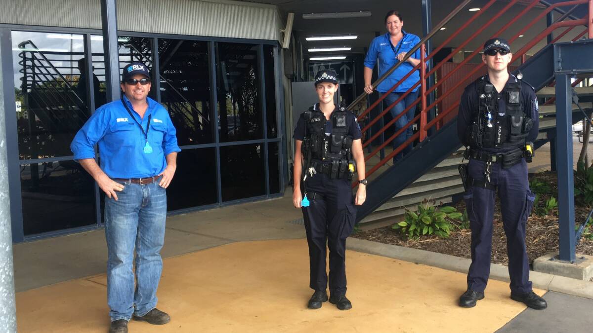 ON WITH THE SHOW: Central Queensland Livestock Exchange staff Gavin Tickle and Carly Gaukroger discussing public safety measures with local police officers at Gracemere Sale this week.