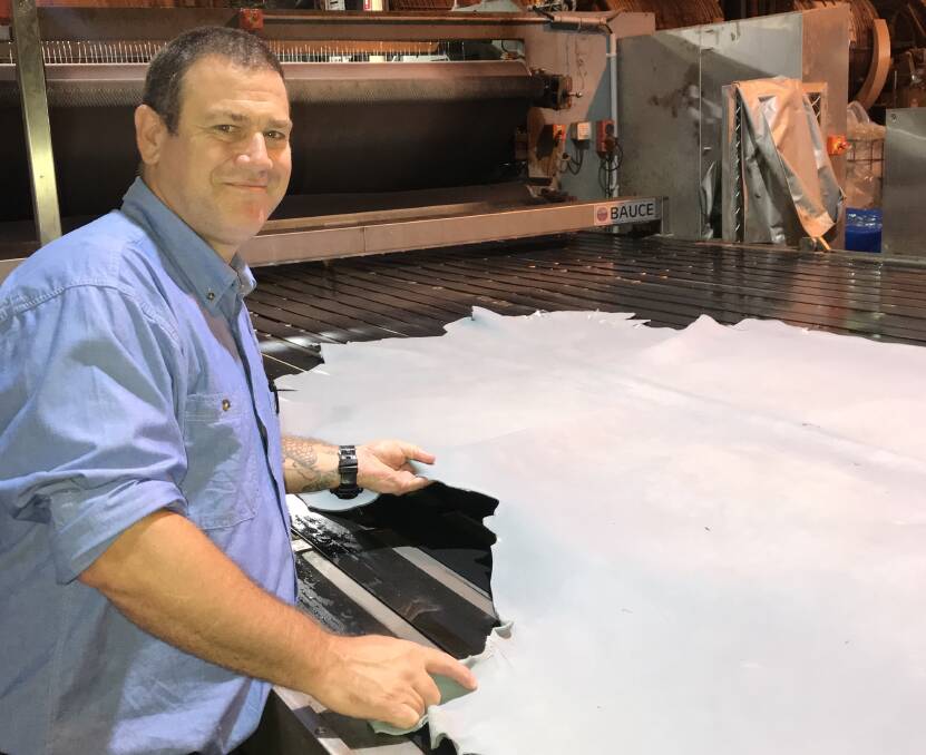 ON THE JOB: Casino Hide Tanners operations manager Shayne Lynch with a piece of wet blue leather. The Northern NSW operation has been blazing new trails in global markets in the face of harsh times in the hide market. 