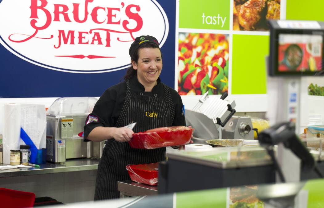 
BUSY DAYS: Carly McLean working in her family's butcher shop at St Anges, South Australia.
