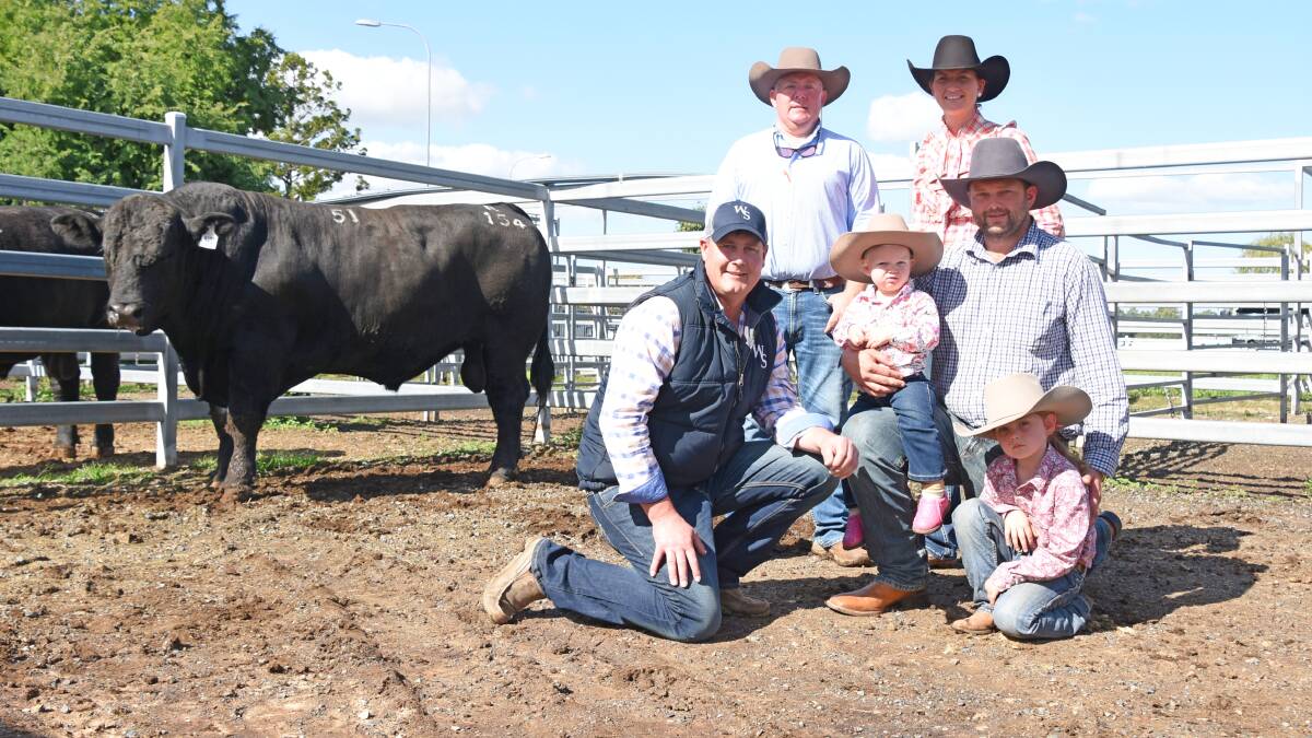 $24,000 Woonallee Ranch R154 pictured with Tom Wilding-Davies (back left) and Tom Baker (front left) Woonallee Simmentals, Millicent, South Australia with buyers Becky and Damian with their two children Pippa and Anna Finger, Farlane Park, Middlemount, Central Queensland.