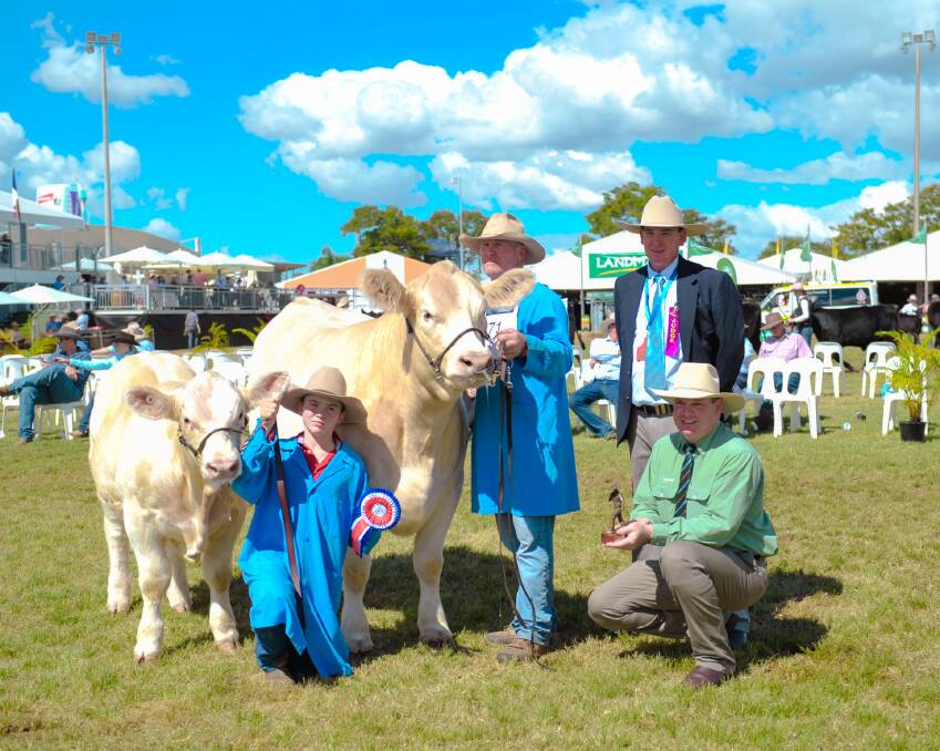 Grand champion Charolais female, Moongool Typhena 9 cow with calf at foot, held by stud princilpe Ivan Price with judge Andrew Chapman and Landmark's James Saunders.