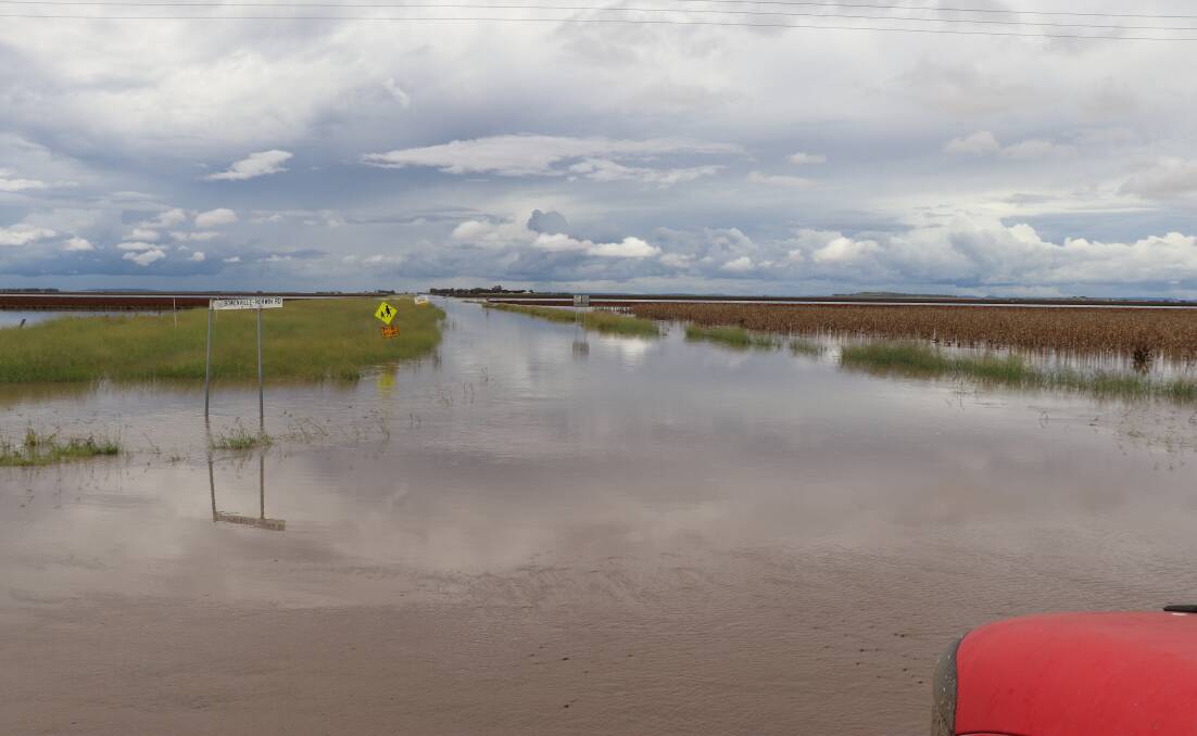 BIG WET: Flood water runs over the road in the West Prairie district west of Toowoomba. Photo: Gayle Pedler.