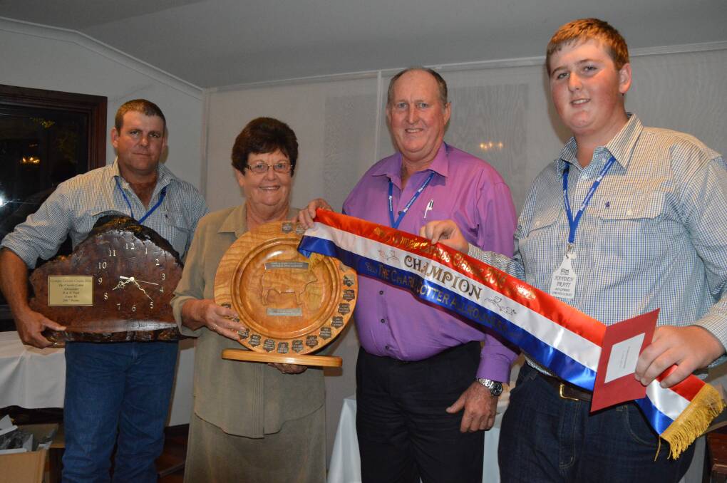 Dan Sullivan, Sullivan Livestock, Gympie, and Jan Cotter, Sexton, present the Charlie Cotter All Rounder award to Doug and Hayden Pratt, Chatsworth at the 2016 Gympie Carcass Classic competition.